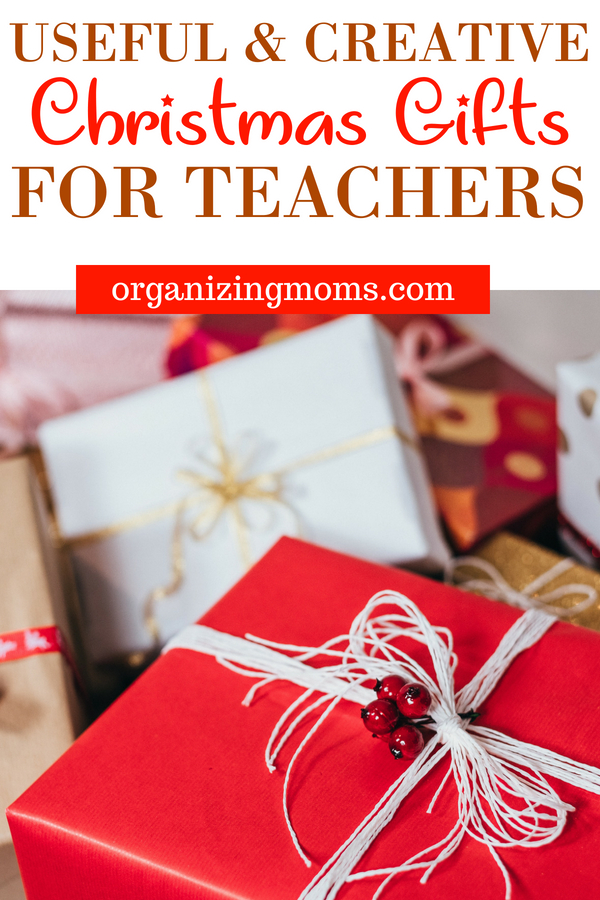 Text - Useful and Creative Christmas Gifts for Teachers organizingmoms.com. Image of Christmas gifts piled on floor.