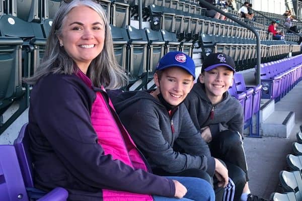 Katie and kids at Coors Field sitting in purple row