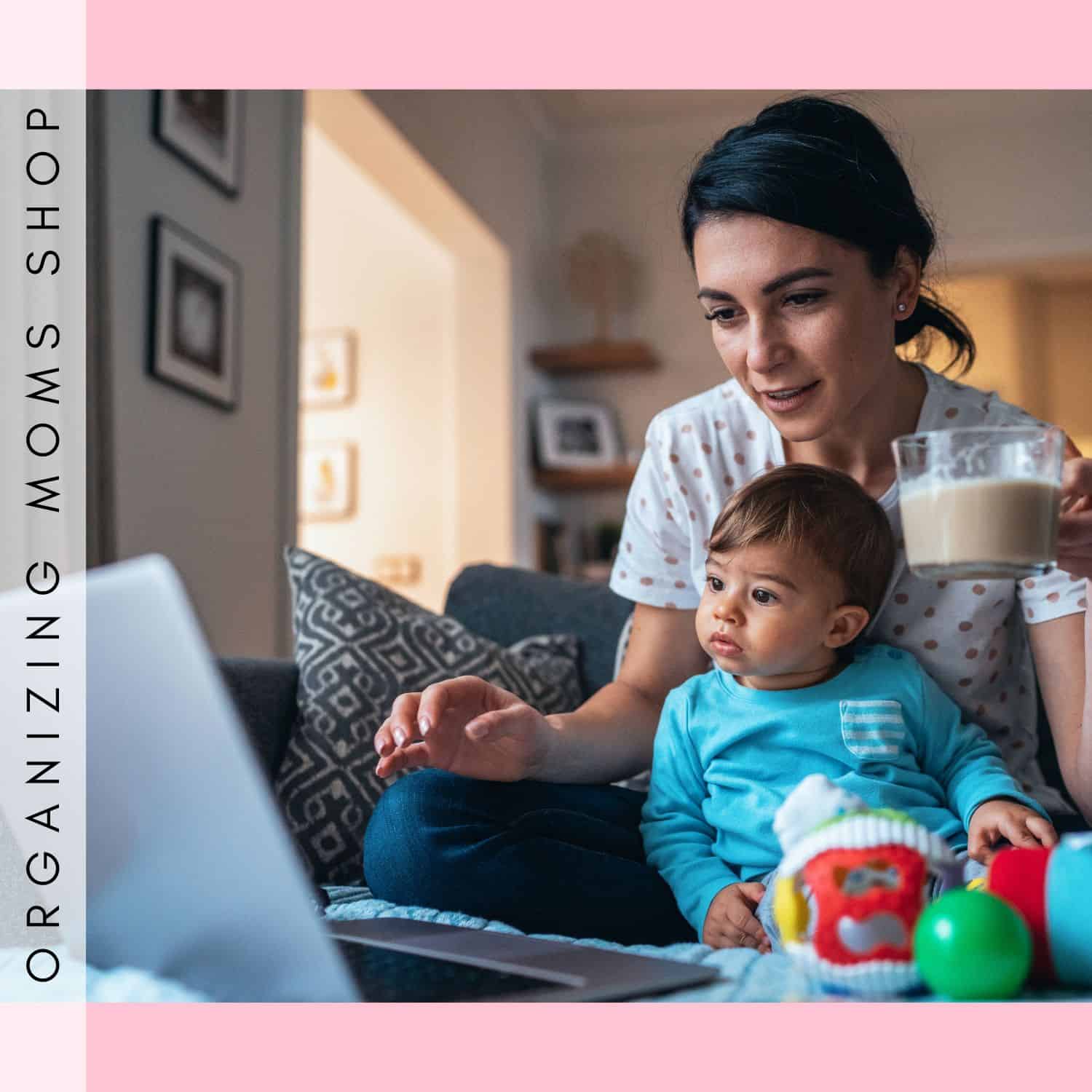 Mom shopping on Organizing Shop with baby. Holding coffee looking at laptop.