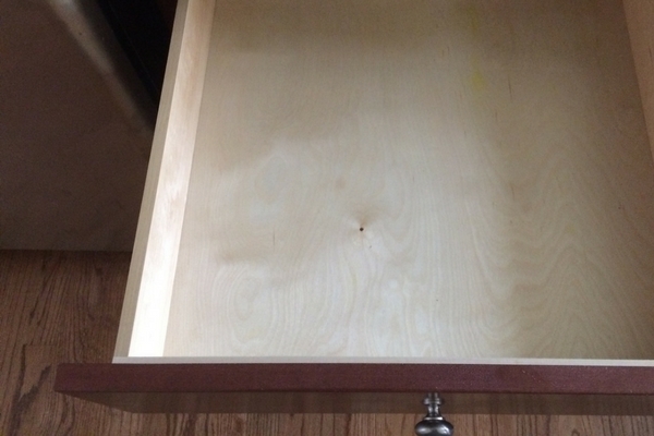 Close up of an empty wooden drawer in kitchen