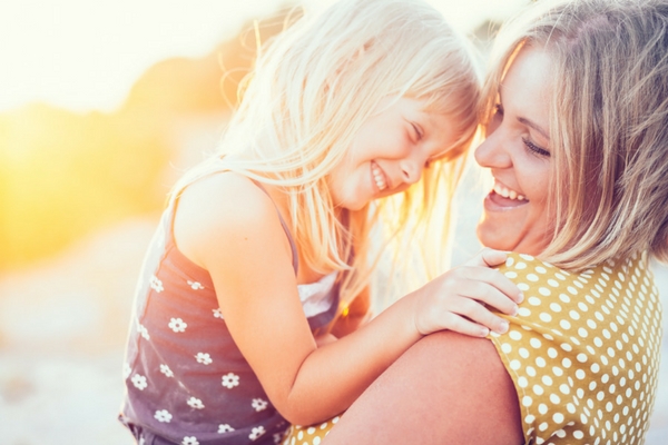 Mom and daughter hugging and laughing