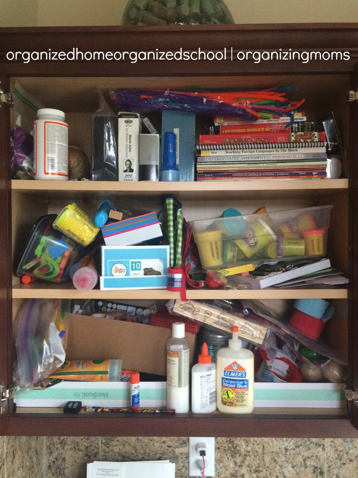 Messy cabinet before organizing children's art supplies.