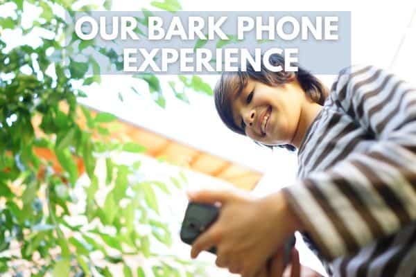 Image of boy looking at cell phone and smiling. Text says Our Bark Phone Experience.