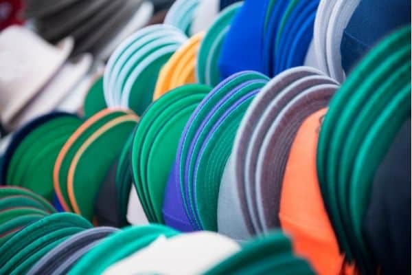 colorful baseball hats stacked together