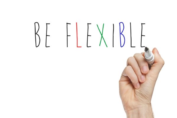 Text on whiteboard: Be flexible. Hand writing letters with marker