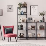 organized black shelf with red chair and lamp