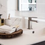 sink with folded towel, soap, toothbrush to symbolize bathroom organization