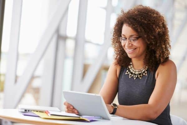 professional woman smiling looking at report