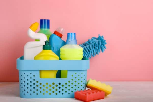 blue cleaning basket from dollar store filled with cleaning supplies