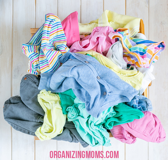 A pile of clothes on a white wooden table