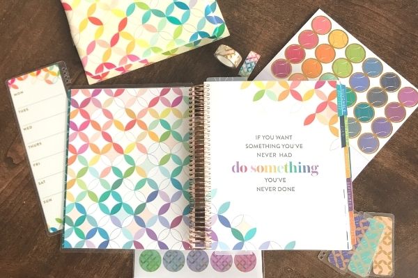 erin condren life planner opened with stickers and tape surrounding