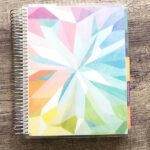 A close up of Erin Condren Life Planner on wooden table