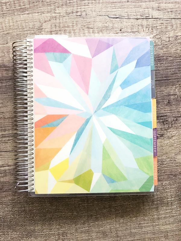 A close up of Erin Condren Life Planner on wooden table