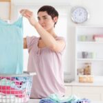 Woman folding clothes in laundry room