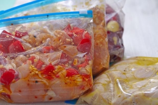 A close up of frozen food freezer meals in plastic bags