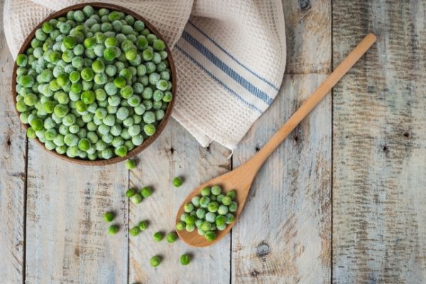 frozen peas on a wooden table