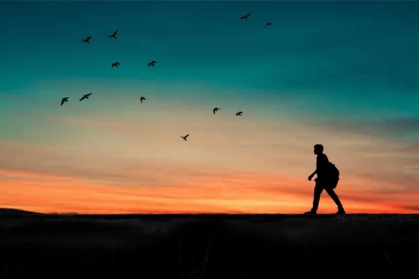 person walking in front of sunset to illustrate get more steps each day