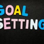 colorful letters spell out goal setting on black background