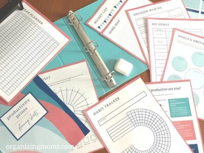 printables and blue binder spread out on table so we can show how to create a custom planner with printables