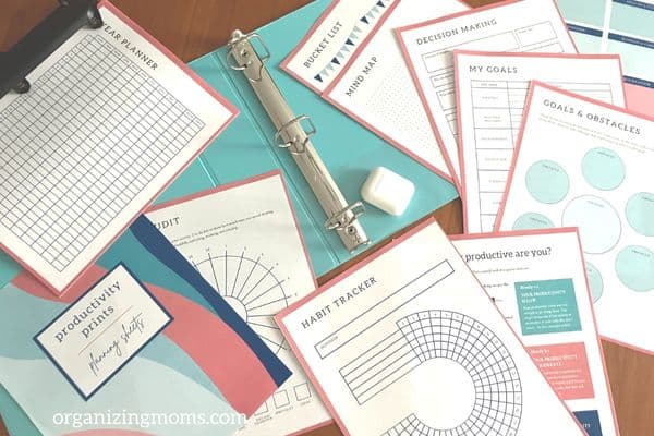 printables and blue binder spread out on table so we can show how to create a custom planner with printables