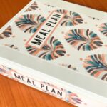 beautiful meal plan binder on wooden table