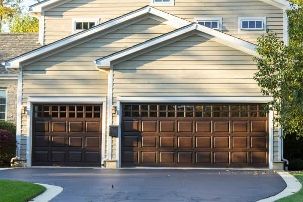 wooden garage doors on tan house