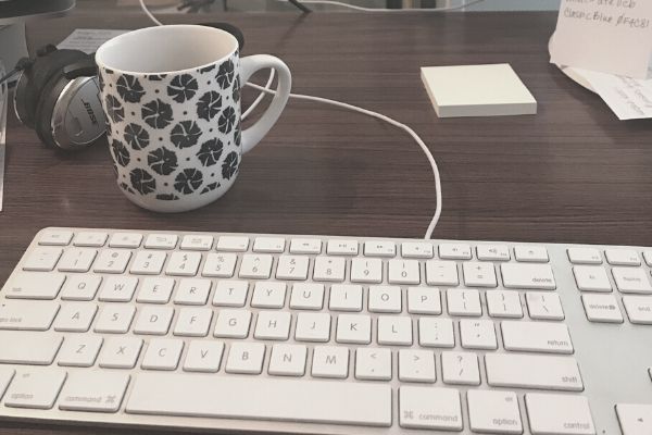 keyboard and coffee mug on desk