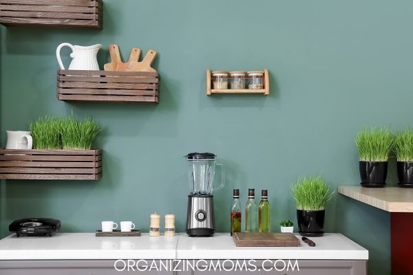 Kitchen countertop in a tidy kitchen with blue wall, white countertop