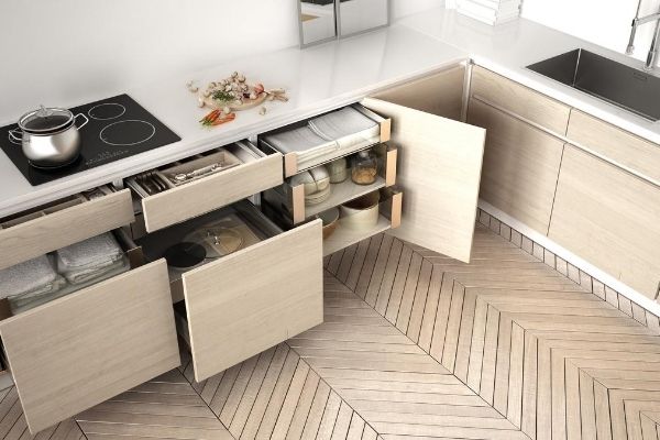 Kitchen storage drawers and cabinets open to show organized contents