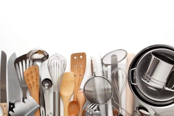 cooking utensils lined up on white background