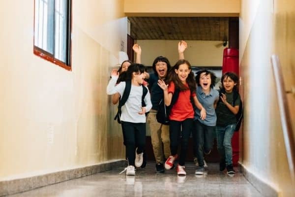 happy kids running down hallway on last day of school