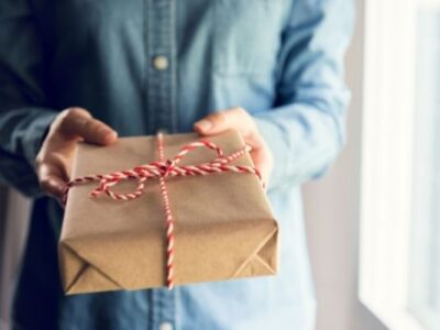 man holding gift to symbolize gift ideas for person who has everything