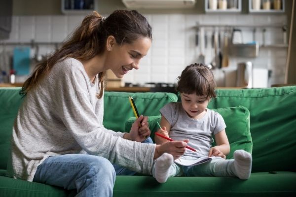 mothers helper playing with little girl