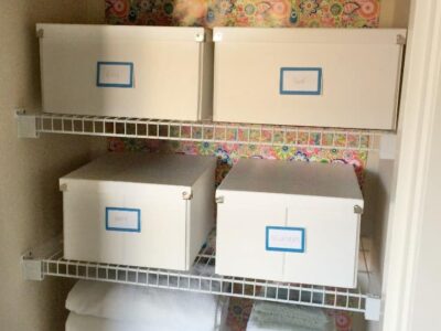 Linen closet organization with versatile boxes. A great way to contain linens and toiletries!