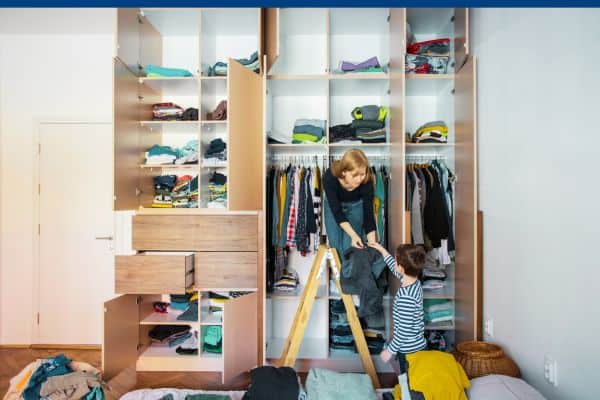 Mom and son organize large closet cabinets.