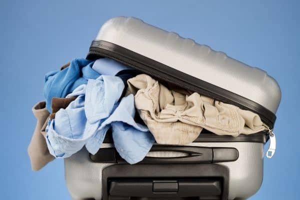 suitcase overstuffed with clothes
