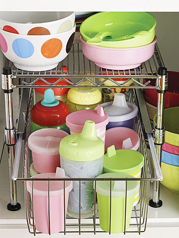 Sippy cups organized in metal drawer organize in bottom cabinet.