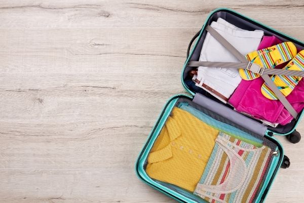 Organized suitcase sitting on top of a wooden table