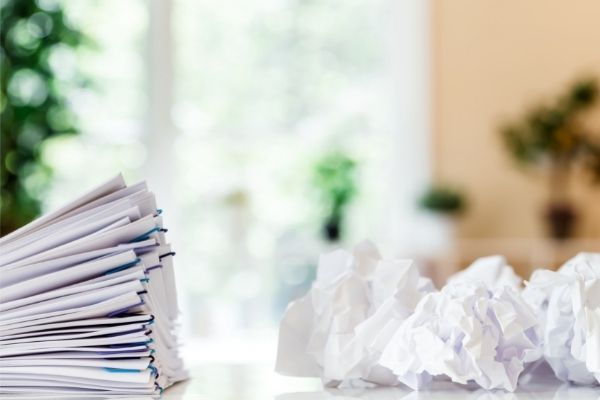 Crumpled papers and stack of documents in paper organization system