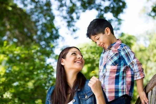 mom and son smiling at each other outside