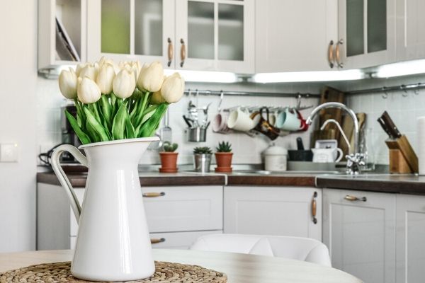 A vase of flowers on a kitchen counter