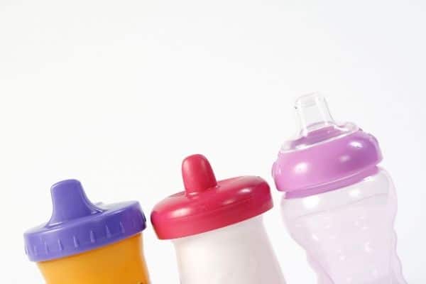 three sippy cups on white background