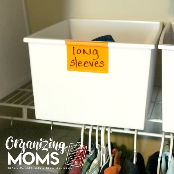 Store extra clothes for kids in extra bins with dry erase labels.