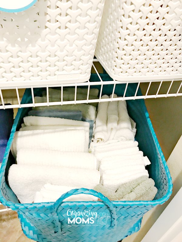 Store hand towels and washcloths in basket in linen closet for easy access and simple organization.