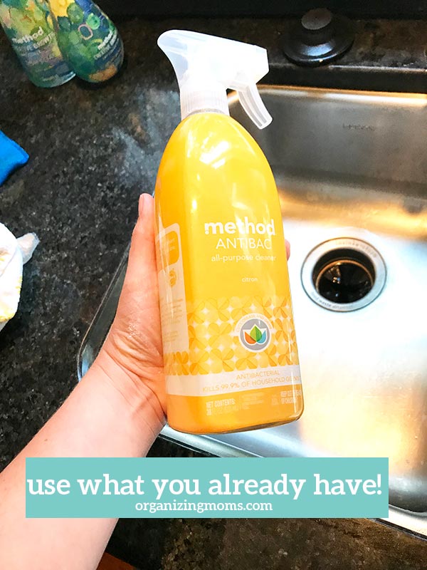 Text - use what you already have organizingmoms.com. Image of yellow Method cleaner bottle in front of clean stainless steel sink.