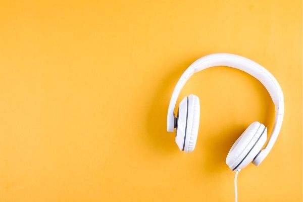 white headphones on yellow background