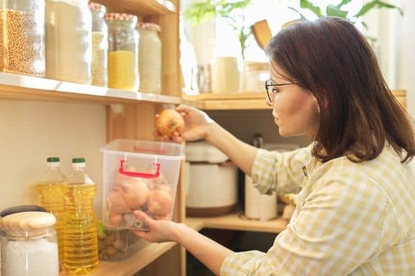 woman doing pantry inventory counting onions