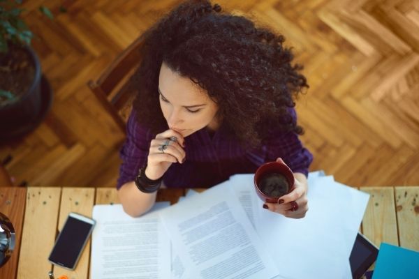 woman working at desk and drinking coffee