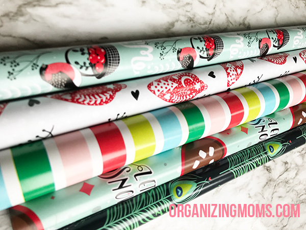 A close up of rolls of Christmas wrapping paper.